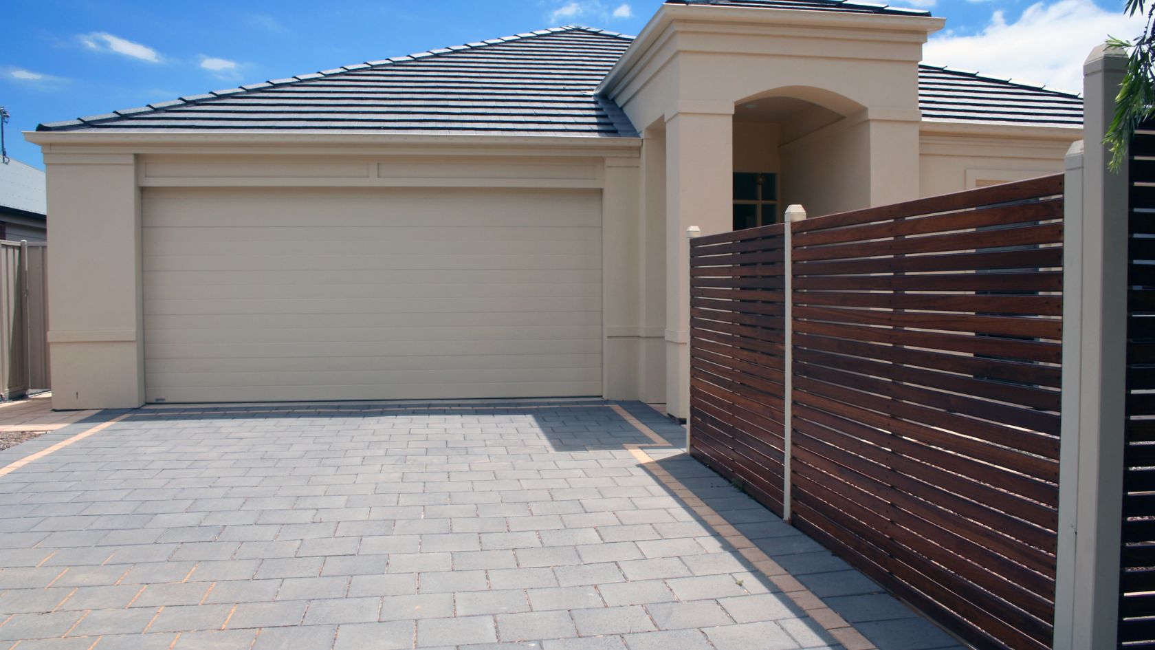 A house with a gate and a brick driveway