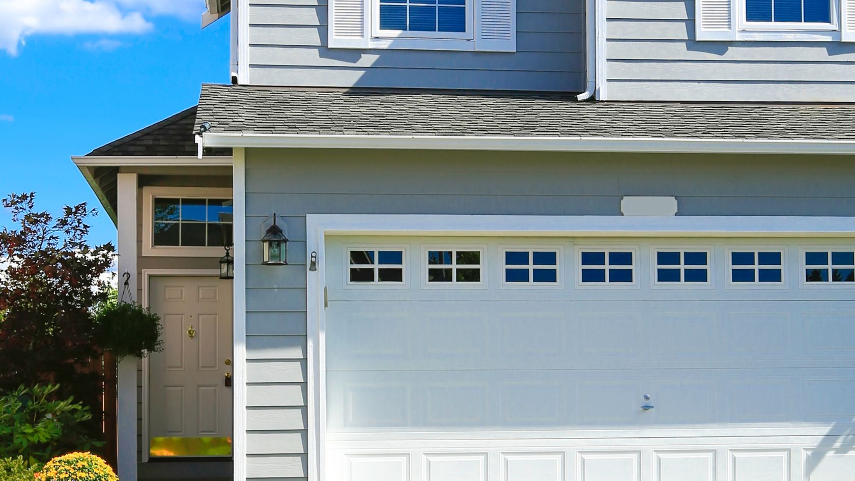 A house with a white garage door and windows